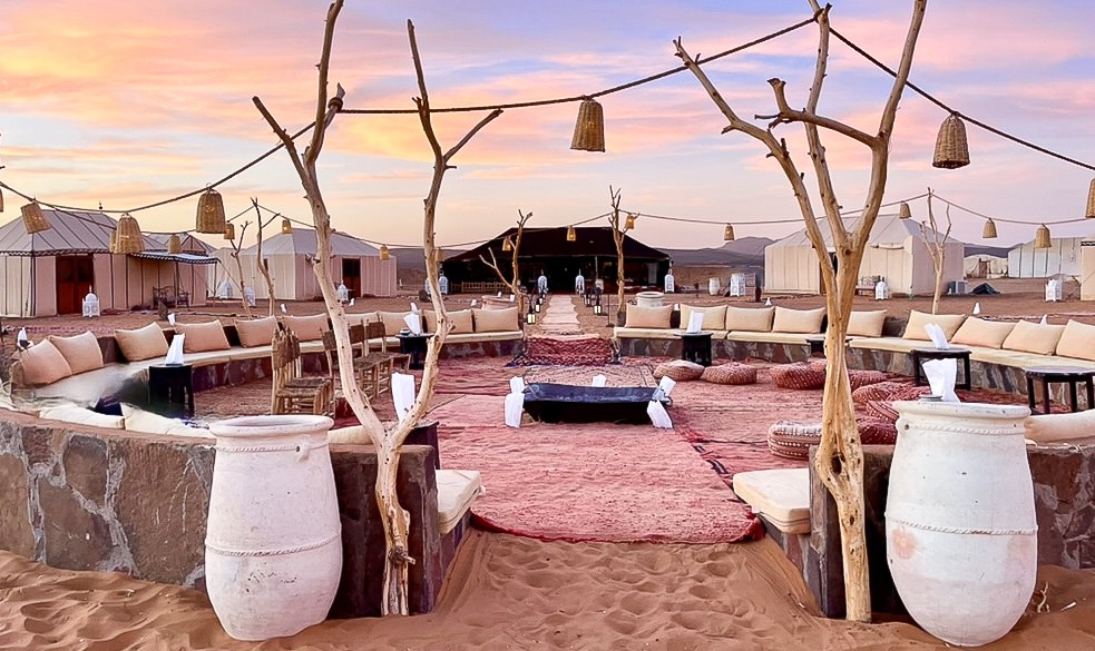 Morocco desert camp at sunset, affordable luxury hotel